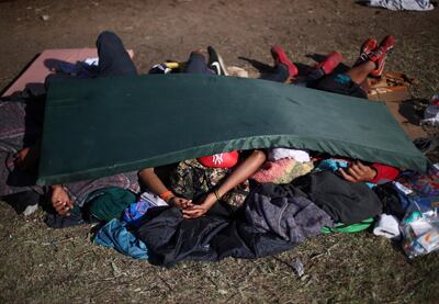 Migrants, part of a caravan of thousands from Central America trying to reach the United States, sleep on the ground at a shelter in Tijuana. Reuters