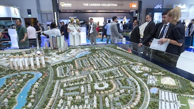 Above, visitors to the Falconcity of Wonders stand. Antonie Robertson / The National