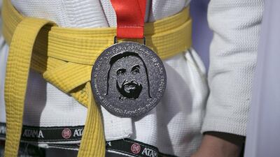 ABU DHABI, UNITED ARAB EMIRATES, Apr. 21, 2015: A boy wears his freshly acquired silver medal during the 2015 Abu Dhabi World Professional Jiu-Jitsu Championship, Children’s Cup, April 21, 2015, at the IPIC Arena in Abu Dhabi. Silvia Razgova / The National