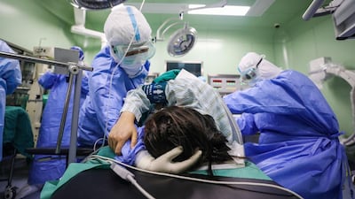 A doctor comforts a pregnant woman infected with coronavirus at an isolation ward in Xiehe Hospital in Wuhan, China. AFP