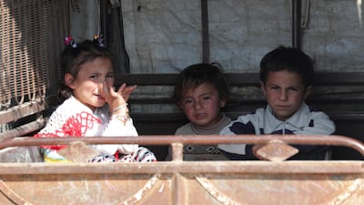 Children sit in an auto rickshaw in Tal Abyad. Reuters