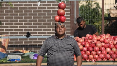 A Palestinian vendor waits to sell pomegranate in a street near the West Bank city of Qalqilya. EPA