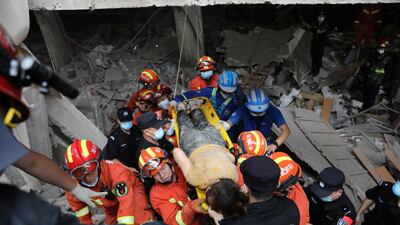 Rescue workers carry an injured woman as they search for victims after a gas pipeline explosion in Shiyan, Hubei province, China. Reuters