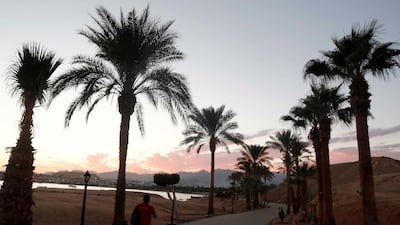 A man walks during sunset at the beach in Sharm El Sheikh, Egypt.