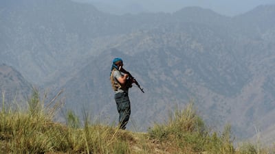 Afghan security forces keep watch near the site of a US air strike on a civilian vehicle in Haska Mina district in Nangarhar province. AFP