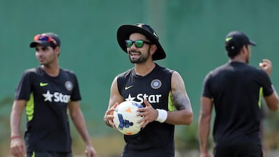 India captain Virat Kohli holds a football during Monday's training session for the first Test of the summer against Bangladesh starting Wednesday in Dhaka. AM Ahad / AP