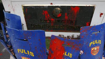 Protesters threw red paint in Manila.