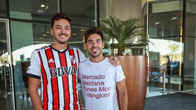 Matias Costas, 26, left, and Federico Gaido, 26, smile as they get ready to watch their team's game against Al Ain.
