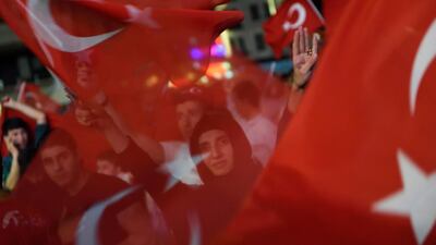 Erdogan supporters wave Turkish flags as they gather at Taksim square. Daniel Mihailescu / AFP Photo