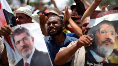 Egyptian supporters of deposed president Mohammed Morsi attend a rally supporting the former Islamist leader outside Cairo's Rabaa Al Adawiya mosque.