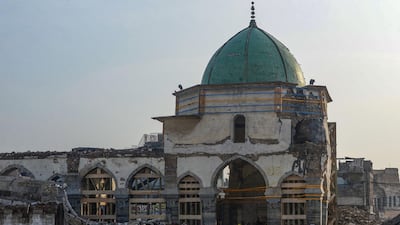 An Iraqi worker enters the Great Mosque of Al-Nuri during the complex's reconstruction in Mosul. AFP