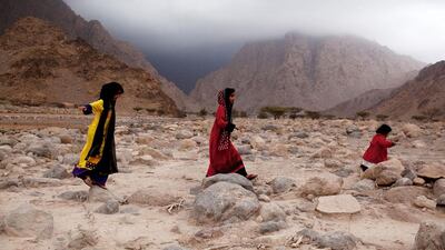 Local children play as they wait to be able to cross a washed out road in Wadi Khab Shamis north of Dibba in Musandam, Oman. Christopher Pike / The National