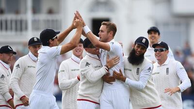 Stuart Broad mobbed after taking the wicket of Chris Rogers. Laurence Griffiths / Getty Images