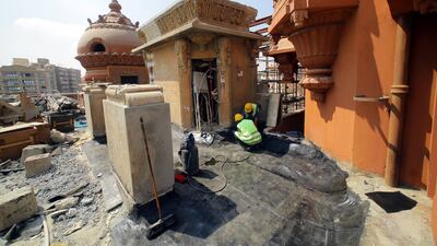 People work on the restoration of the Baron Palace during a inspection tour. EPA