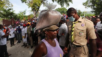 Camp Perrin residents receive food from the World Food Programme near Les Cayes on Thursday. Reuters