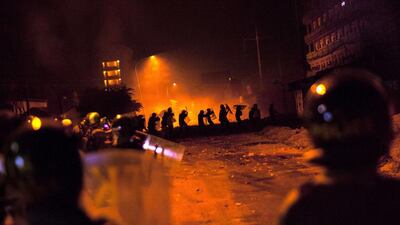Cambodian police stand guard during a garment workers' protest to demand higher wages in front of a factory in Phnom Penh on JFriday. Luc Forsyth / AFP
