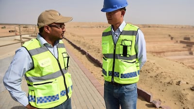 Chinese Technical Director Yan Bing Bing, right, talks with a Pakistani co-worker at an open-pit coal mining site at Islamkot in the desert in the Tharparkar district of Pakistan's southern Sindh province. AFP