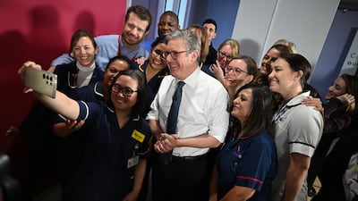 Mr Starmer poses for a photo after giving a speech on reducing NHS waiting times in January 2025 in Epsom. Getty Images