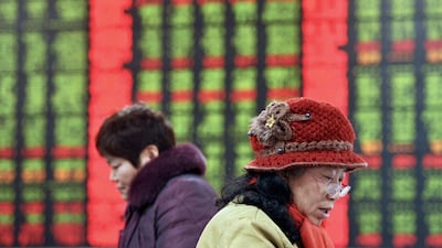 Chinese stock investors check prices at a brokerage house in Fuyang in central China's Anhui province on Thursday, January 21, 2016. Chinatopix via AP