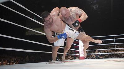 Abu Dhabi Warriors' Travis Wiuff, right, takes down Maro Perak in action during the main event of the Abu Dhabi Warriors Fighting Championship in 2012. Mike Young / The National