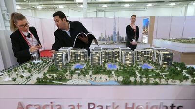 Prospective buyers view a mock up of Emaar’s newly launched Acacia at Park Heights development at the Dubai Property show in London. Stephen Lock for the National