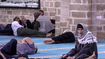 Palestinians take rest before their breakfast in Al Omari mosque in Gaza City. EPA