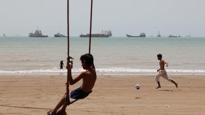 A child plays on the beach in Bandar Abbas, Iran, as vessels start to cross the Strait of Hormuz. Reuters