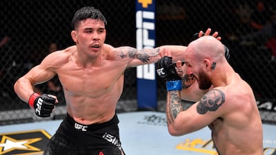 Ricky Simon, left, punches Brian Kelleher in their featherweight fight during the UFC 258 event at UFC APEX in Las Vegas, Nevada. Jeff Bottari / Zuffa LLC / UFC