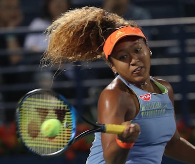 Japan's Naomi Osaka returns the ball to France's Kristina Mladenovic during day one of the WTA Dubai Duty Free Tennis Championship at the Dubai Tennis Stadium. Karim Sahib / AFP