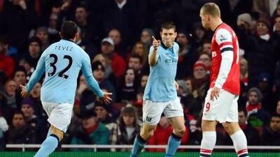Manchester City's English midfielder James Milner celebrates scoring the opening goal at the Emirates Stadium.
