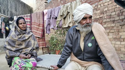 Balbir Singh, 65, sits outside his home with his wife Kulwant Kaur during his first visit home after 48 days taking part in the demonstrations.