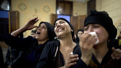 Relatives of killed Coptic Christians grieve during their funeral at Abu Garnous Cathedral in Minya, Egypt, Friday, May 26, 2017. AP Photo/Amr Nabil