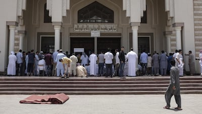 Worshippers prepare for noon prayers in Ajman outside Sheikh Zayed Mosque. Antonie Robertson / The National