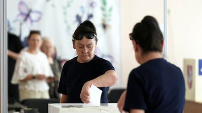 A woman casts her vote during the second round of presidential election in Panevezys, Lithuania. Reuters