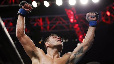 Rafael dos Anjos celebrates winning the men's lightweight title at UFC 185 on Saturday night. Brandon Wade / AP