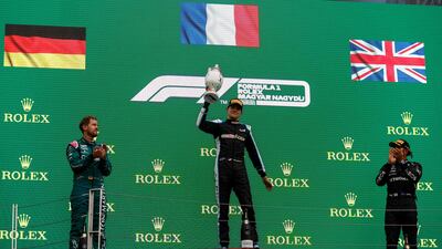Aston Martin's Sebastian Vettel, Alpine's Esteban Ocon and Mercedes' Lewis Hamilton celebrate on the podium after the Hungarian Grand Prix at the Hungaroring on Sunday, August 1, 2021.