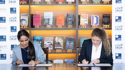 Fiker Institute founder Dubai Abulhoul, left, and Global Security Programme director Dr Annette Idler sign the agreement. Photo: Fiker Institute