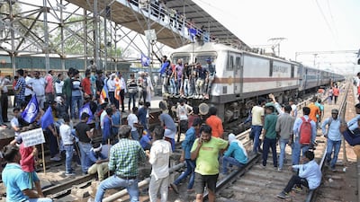 Members of the Indian Dalit community block a train at a station during a countrywide strike against the Supreme Court order that allegedly diluted the Scheduled Castes and Scheduled Tribes (Prevention of Atrocities) Act, in Mathura in Uttar Pradesh state April 2018. AFP