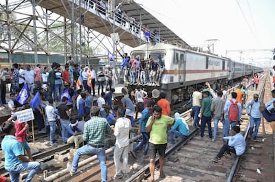 Members of the Indian Dalit community block a train at a station during a countrywide strike against the Supreme Court order that allegedly diluted the Scheduled Castes and Scheduled Tribes (Prevention of Atrocities) Act, in Mathura in Uttar Pradesh state April 2018. AFP