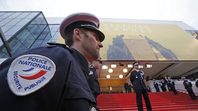 French police officers stand at attention before arrivals on the red carpet for the opening ceremony and the screening of the film Cafe Society out of competition during the 69th Cannes Film Festival in Cannes, France, May 11, 2016. REUTERS / Eric Gaillard