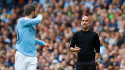 Manchester City manager Pep Guardiola gestures to Bernardo Silva during their 34th unbeaten match in a row against promoted teams at the Etihad Stadium. Reuters