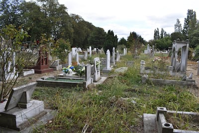 Old headstones wedged into the perimeter fence of Tottenham Park Cemetery, where locals believe old graves are being dug up to make way for new burial sites. Gareth Browne / The National