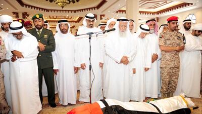 Sheikh Saif bin Mohammed, Sheikh Khalid bin Mohamed bin Zayed, and Sheikh Diab bin Mohamed bin Zayed perform funeral prayers over the body of Capt Hadif Al Shamsi. Wam