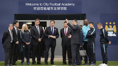 British prime minister David Cameron and Chinese president Xi Jinping with Manchester City chairman Khaldoon Al Mubarak, fourth from right, during a visit to the City Football Academy in Manchester. Wam