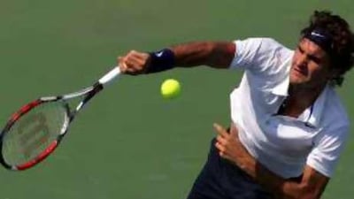 Roger Federer delivers a serve against Robby Ginepri during their clash in Cincinnati. The Swiss player overcame losing the first set to win and maintain his hopes of remaining the world No 1.