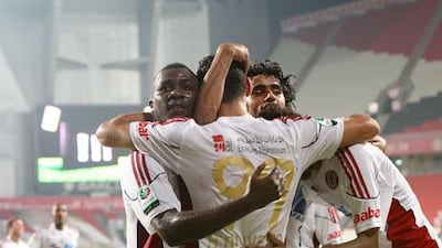 Man-of-the-match Ricardo Oliveira is mobbed by his jubilant teammates at the Mohammed bin Zayed Stadium on Saturday night.