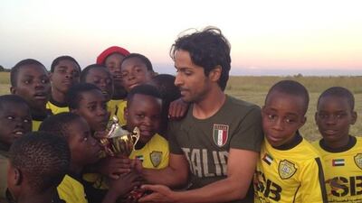 Salem Alkarbi hosts events for disadvantaged children worldwide through his football charity "Beyond the Boundaries of Football". Here he is in Zimbabwe. Courtesy Salem Alkarbi