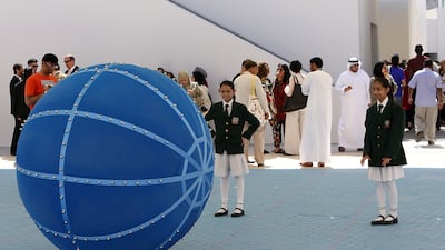 Schoolchildren playing with a giant ball in Al Hamdan bin Mousa Square at Sharjah Biennial 12. Pawan Singh / The National