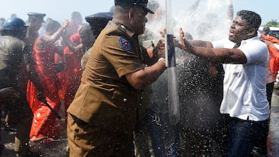 Sri Lankan police use water canons to disperse activists and Buddhist monks clash during a protest in the southern port city of Hambantota on January 7, 2017. Sri Lankan nationalists, monks and local residents are protesting the creation of an industrial zone for Chinese investments on the island. / AFP / Ishara S. KODIKARA