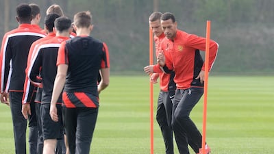 Rio Ferdinand, jogging through the cones ahead of Nemanja Vidic, came in ahead of Serb at Manchester United, but they will leave the club together. Martin Rickett / PA Wire
